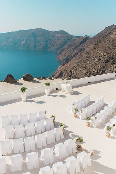 santorini wedding destination venue, ceremony area with chairs by the sea