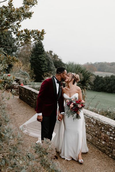 winter wedding at Berkeley Castle with red wedding suit jacket