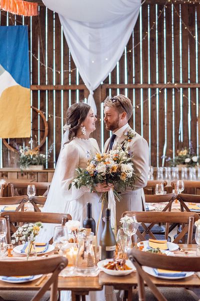 Bride and groom stand together at Deepdale Farm wedding venue for their DIY wedding,