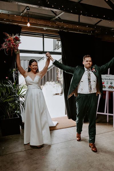 Bride and groom enter their wedding reception 