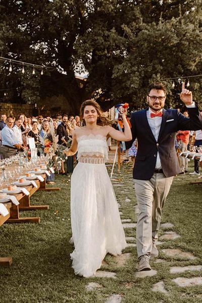 Greece destination wedding with strapless lace boho weddng dress, pampas grass decor, wool rugs & goat table plan by WedPashalis Photography