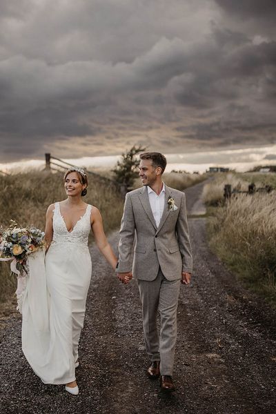 Elmley Nature Reserve wedding with bride and groom walking together