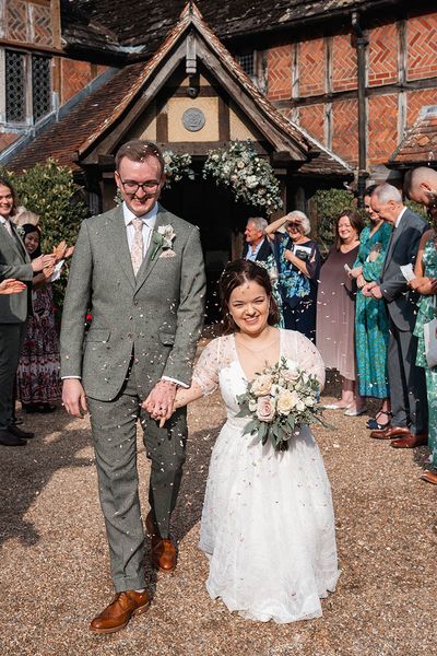 bride and groom have confetti exit at Langshott Manor in Surrey
