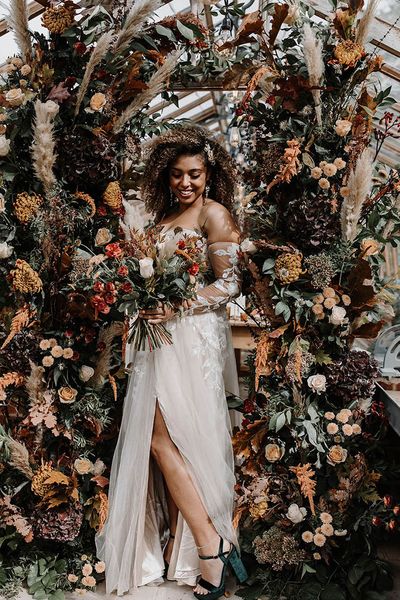 Bride surrounded by flower columns for a glasshouse reception.