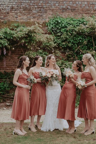 Bridal party wearing midi bridesmaid dresses