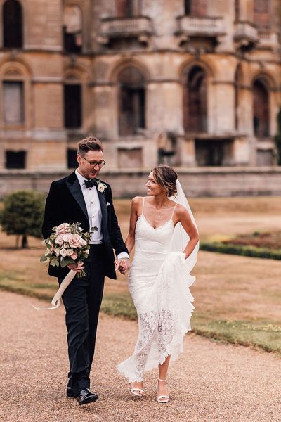 Bride in lace wedding dress and groom in black tuxedo for Hanley Hall Worcestershire wedding.