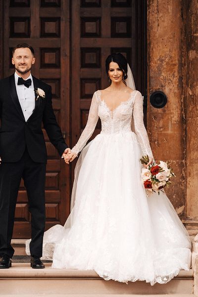 Bride in a Milla Nova princess style wedding dress and groom in black tie.