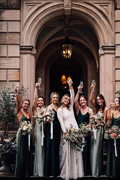 Bride with her bridesmaids in green bridesmaid dresses outside of Callow Hall.