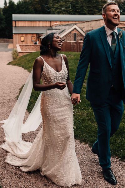 Black bride in a lace wedding dress with Watteau train