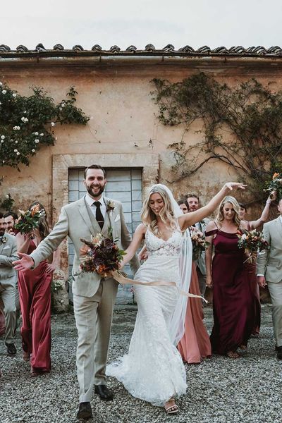 Tuscany destination wedding with lace wedding dress, tambourine favours and terracotta orange bridesmaid dresses