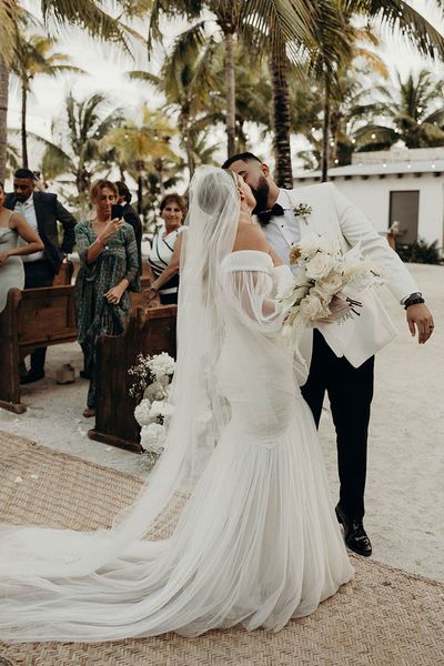 Modern Blue Venado beach wedding with white wedding flowers, disco balls, candles and black bridesmaid dresses by Andre Gouin