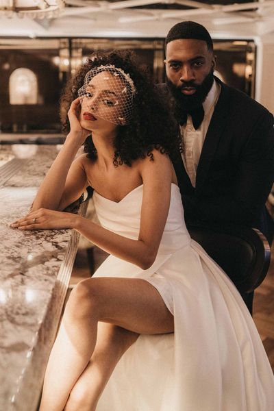 Stylish Mayfair Townhouse wedding inspiration with front slit wedding dress, birdcage veil and velvet suit jacket