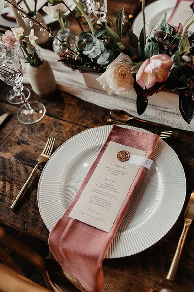 wedding menu card on pink napkin for place setting
