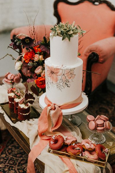 painted wedding cake and terracotta wedding inspiration in an industrial wedding venue