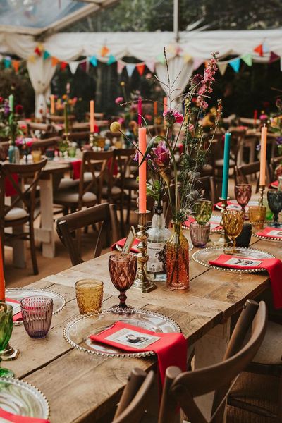 Clear marquee wedding reception in a back garden with colourful flower and table decor 