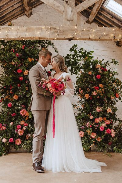 Bride in Sassi Holford wedding dress with the groom for rustic wedding.