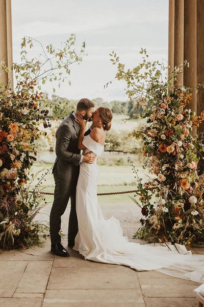 Boho autumnal wedding column flower arrangements.