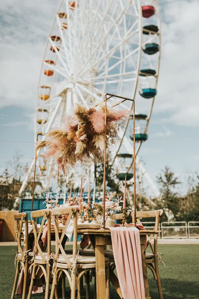 Pastel wedding inspiration at Dreamland Margate with astro slide, ferris wheel and outdoor reception with dried flowers