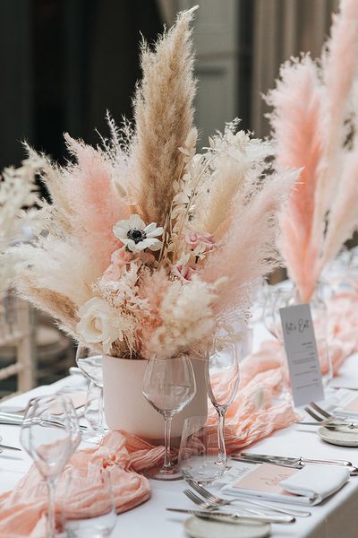 Pink and white pampas grass centrepiece decor for boho wedding.