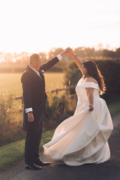 The bride and groom dance together during sunset at Stratton Court Barn Bicester.