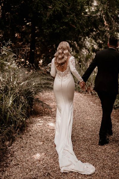 Bride in lace back Badgley Mischka wedding dress and groom in black tie for Pennard House wedding.