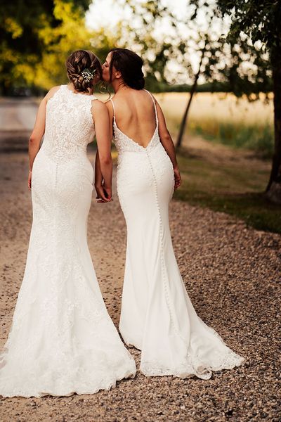 Brides in lace wedding dresses for outdoor summer wedding at Cripps Barn.