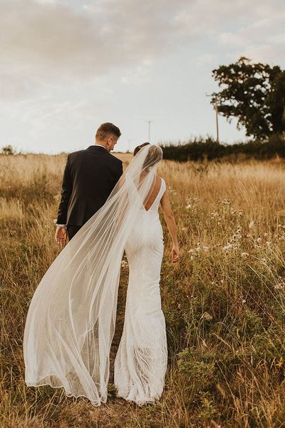 The bride and groom walk together for the wedding at Priston Mill, Bath.