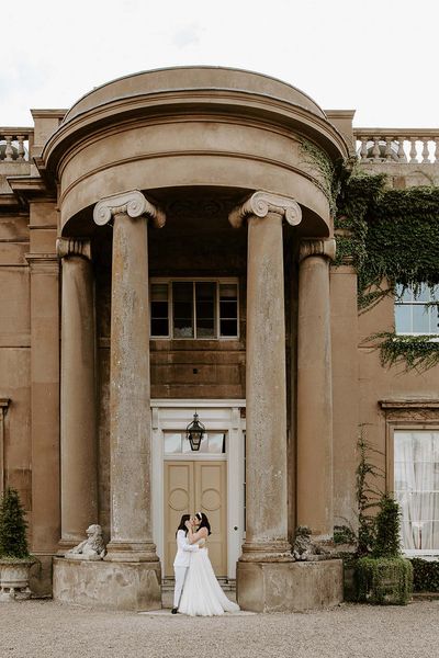 Brides share a kiss at their wilderness reserve wedding 