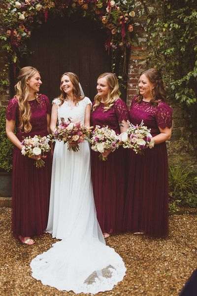 Ramster Hall wedding with bride and bridesmaids in dark red dresses