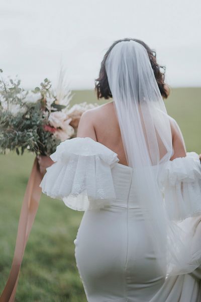 Bride in a fitted Emmy Mae Bridal gown with fun sleeves!