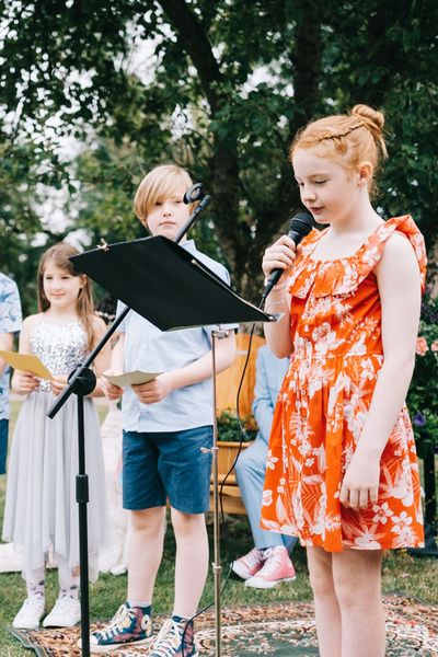 Child performing a reading at a wedding from children's wedding readings.