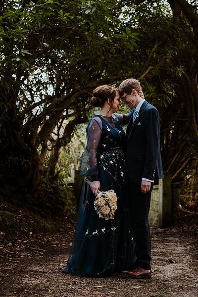 Bride in a bespoke navy blue wedding dress for celestial theme wedding.