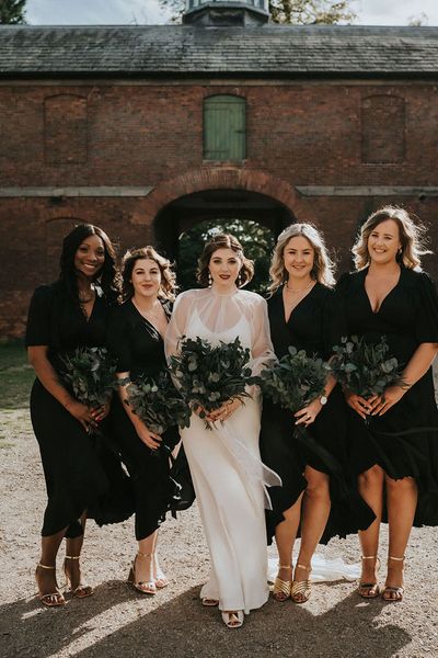 Bride and bridesmaids all holding preserved flower bouquets.