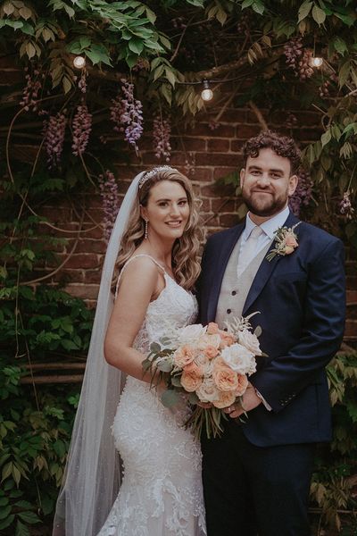 Stanlake Park Wedding with the bride in a lace wedding dress and groom in dark blue suit.