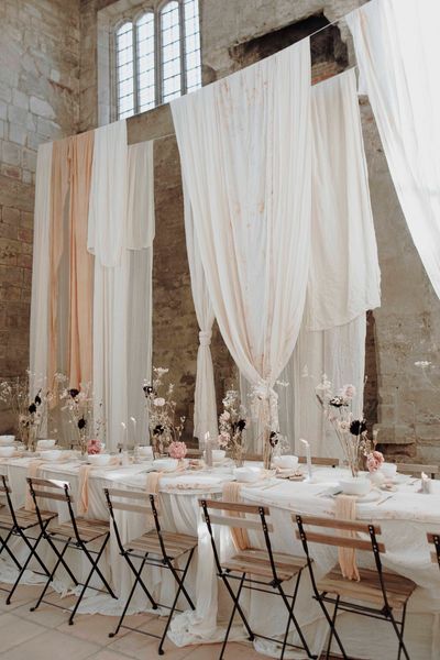 Blackfriars Priory gothic wedding inspiration with drapes, dried flowers and a concrete wedding cake.