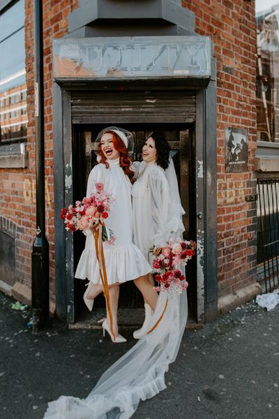 short wedding dress long veil bridal inspiration with red wedding flowers, winged eyeliner and bold lipstick