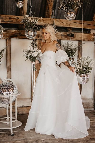 bride at disco wedding with disco ball decor