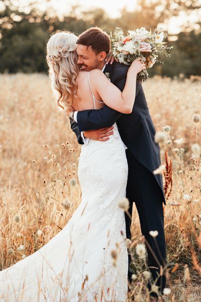 Bride and groom posing together at Rackleys Chiltern Hills barn wedding venue in Buckinghamshire.