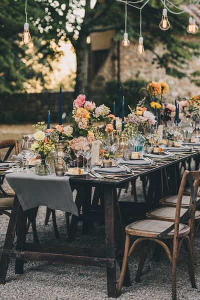 Wedding Table Decorations with candles, table runners, flowers and cutlery