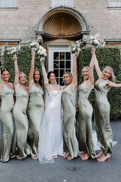 bridal party in green satin bridesmaid dresses