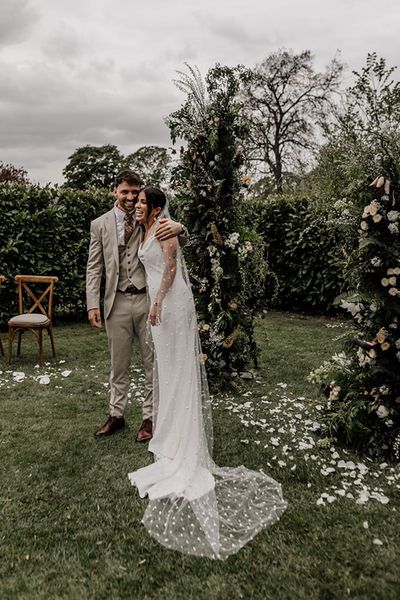 Indian and English multicultural garden wedding with a clear marquee and a bride in a slip wedding dress and pearl veil by Epic Love Story