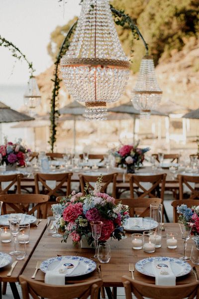 beach bar wedding in Greece with boho wedding dress and pink and blue wedding flowers 