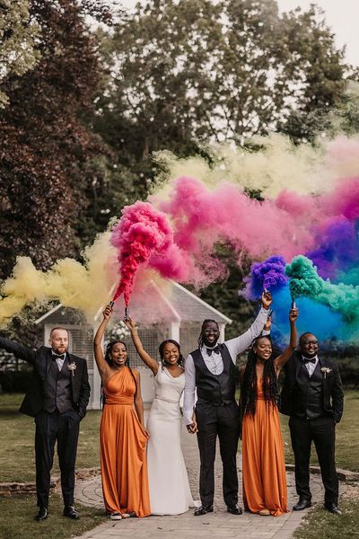 Hayne House wedding with black couple, orange bridesmaid dresses and colourful smoke bomb portraits 