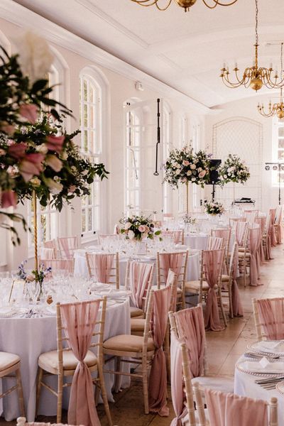 Goldney Hall wedding venue with pink chairbacks and decor.