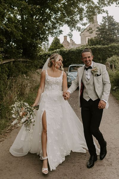 Bride in Eleganza Sposa Iconic wedding dress with groom. 