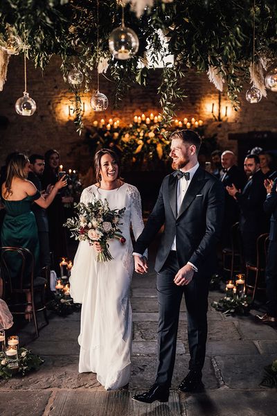 Bride in a long sleeve Atelier Pronovias wedding dress with the groom in black tie