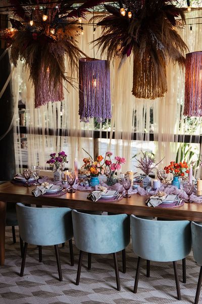 Brazil destination wedding at villa mandacaru with purple theme tablescape and statement hanging lights