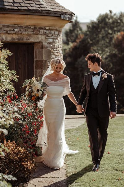 Bride in a tulle Halfpenny London wedding dress with groom in black tie for wedding at The Saddle Room.