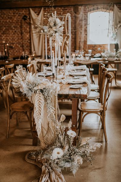 bohemian luxe wedding in a barn with white flowers and natural decor 