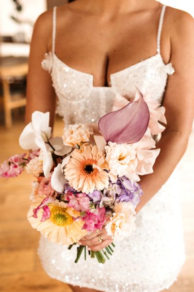 Gorgeous bride O with her bespoke Sweet Pea Sorbet bouquet, featuring lots of beautiful spring stems designed in a pastel colour palette. Captured by Hollie Carlin Photography.